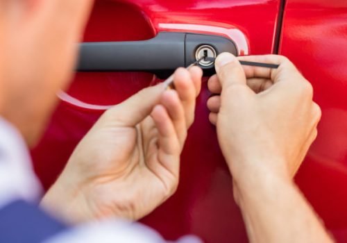 Close-up Of Person's Hand Opening Car Door With Lockpicker